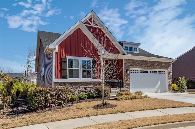 craftsman-style house with a garage, stone siding, board and batten siding, and concrete driveway