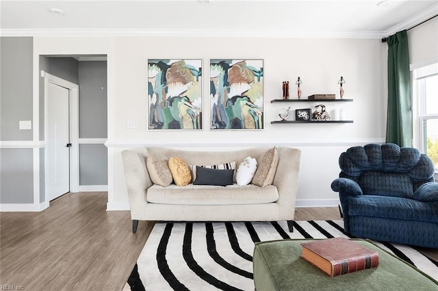 living room with crown molding, baseboards, and wood finished floors