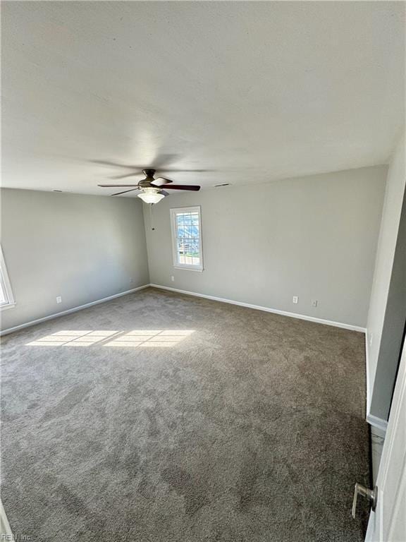 empty room with ceiling fan, baseboards, and carpet flooring