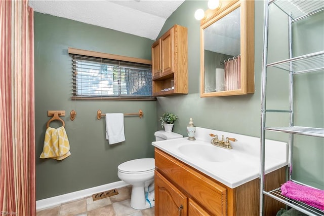 bathroom featuring a textured ceiling, toilet, vanity, visible vents, and baseboards