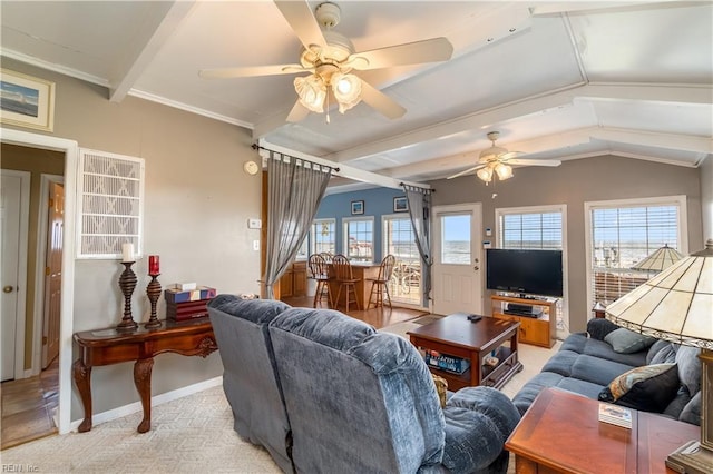 living room featuring light colored carpet, a healthy amount of sunlight, crown molding, and baseboards