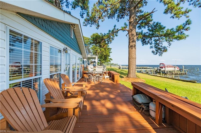 deck featuring a lawn and a water view