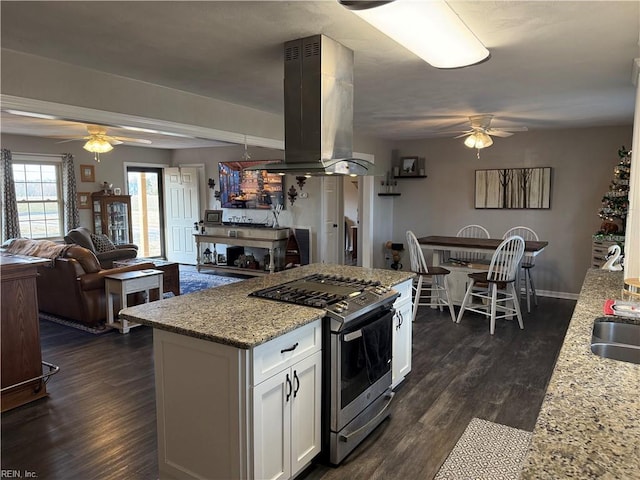 kitchen featuring white cabinetry, stainless steel range with gas cooktop, island range hood, and dark wood-style flooring