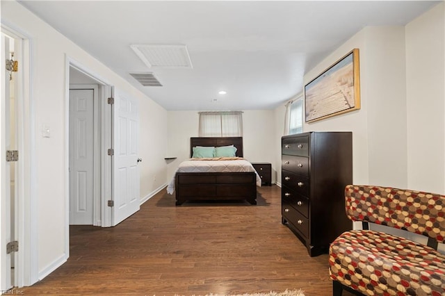 bedroom featuring wood finished floors, visible vents, and baseboards