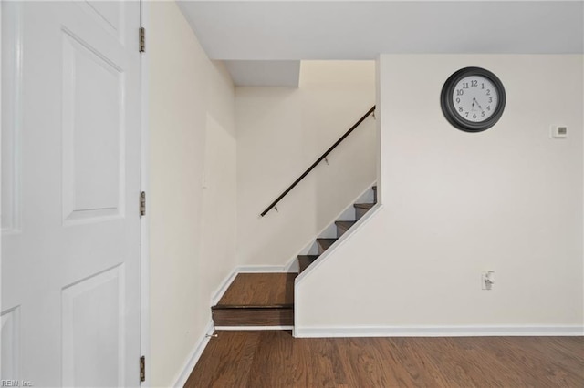 stairway featuring wood finished floors and baseboards