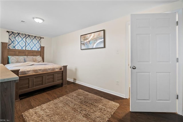 bedroom featuring baseboards, visible vents, and dark wood-type flooring