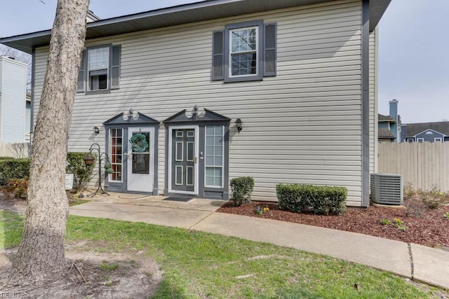 view of front of home featuring fence and a patio