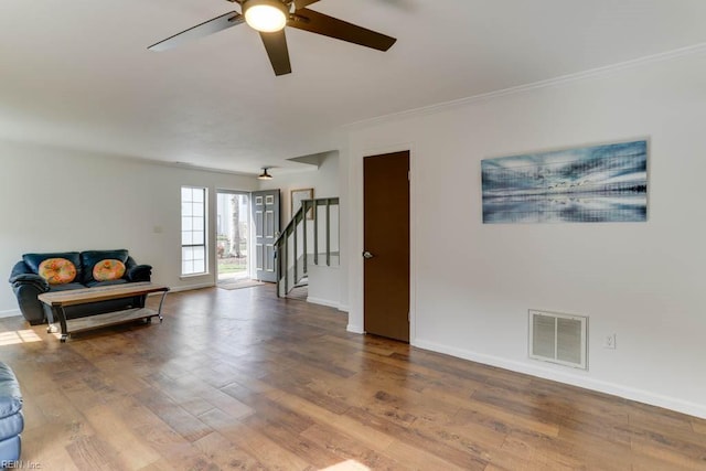 interior space with visible vents, stairway, baseboards, and wood finished floors