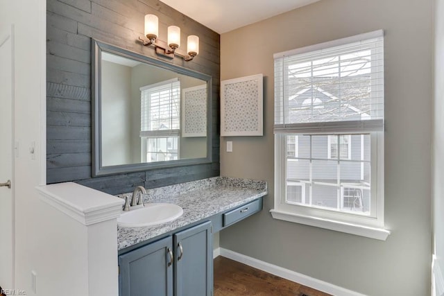 bathroom with vanity, baseboards, and wood finished floors