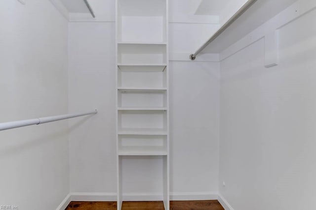 walk in closet with wood finished floors