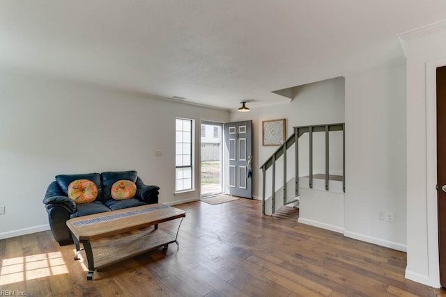 foyer entrance featuring wood finished floors, baseboards, and stairs