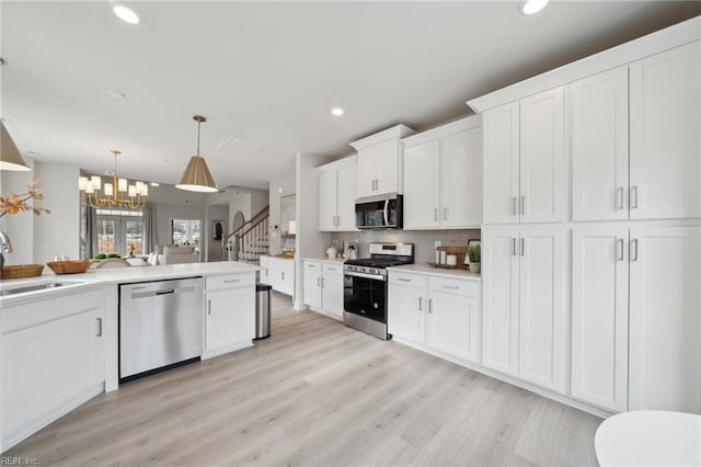 kitchen with appliances with stainless steel finishes, recessed lighting, and a sink