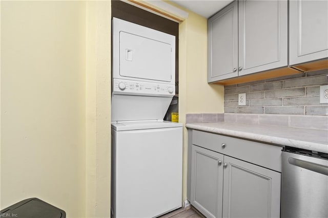 laundry area with stacked washing maching and dryer