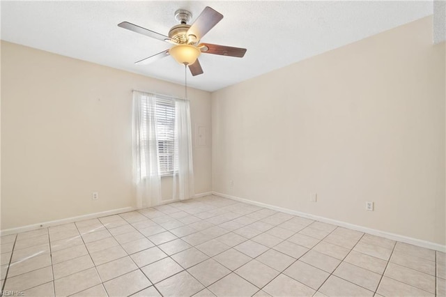 unfurnished room with ceiling fan and baseboards