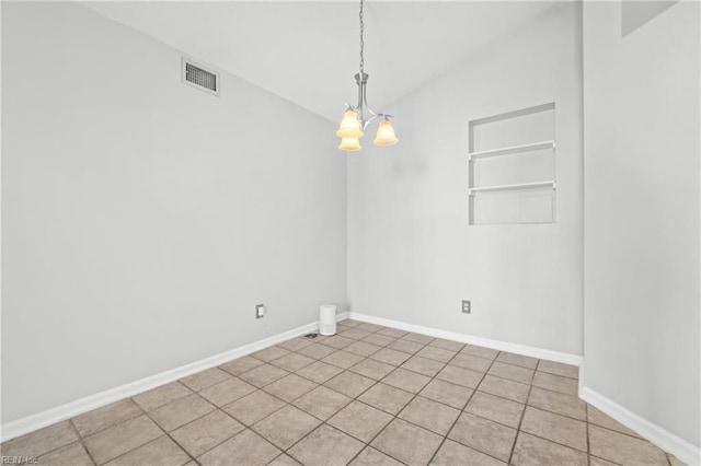 empty room featuring lofted ceiling, visible vents, baseboards, and an inviting chandelier