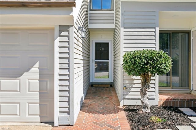 doorway to property with a garage