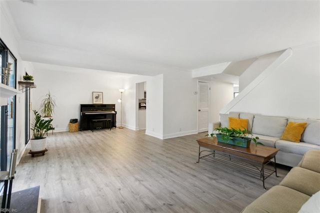 living area featuring baseboards and wood finished floors