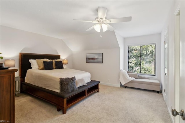 bedroom featuring ceiling fan, baseboards, vaulted ceiling, and light colored carpet