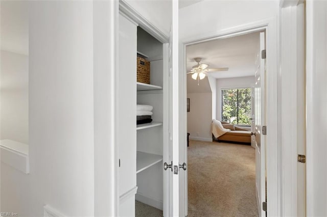 hall with carpet and baseboards