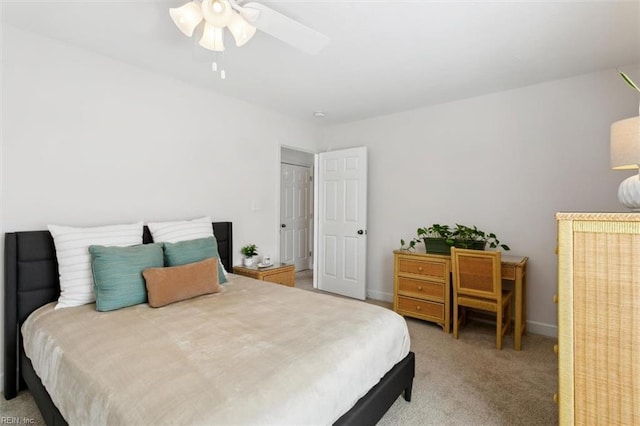 bedroom with ceiling fan, baseboards, and carpet flooring