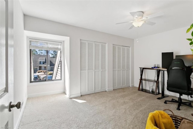 carpeted office featuring ceiling fan and baseboards