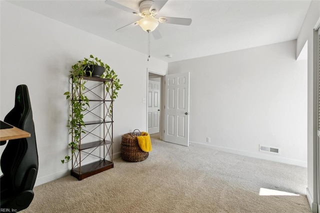 carpeted office space featuring a ceiling fan, visible vents, and baseboards