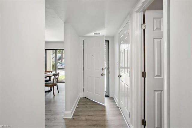 entrance foyer featuring dark wood-style floors, visible vents, and baseboards