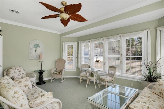 living room with crown molding, plenty of natural light, baseboards, and carpet floors