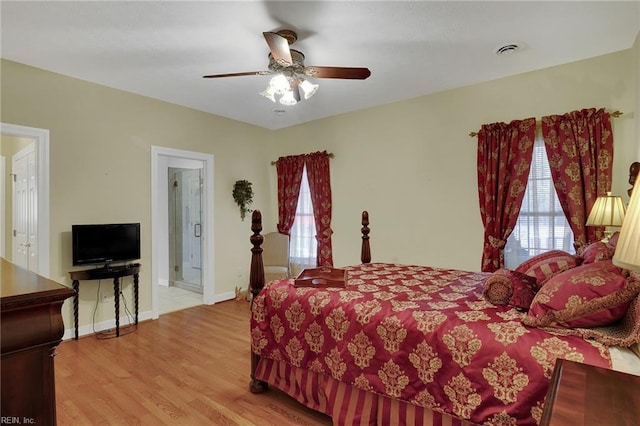 bedroom with visible vents, ceiling fan, baseboards, and wood finished floors