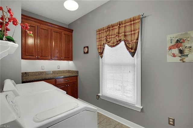 washroom featuring baseboards, cabinet space, independent washer and dryer, and a healthy amount of sunlight