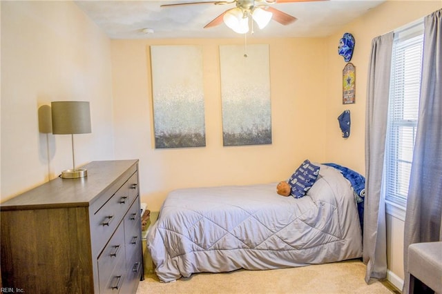 carpeted bedroom with a ceiling fan