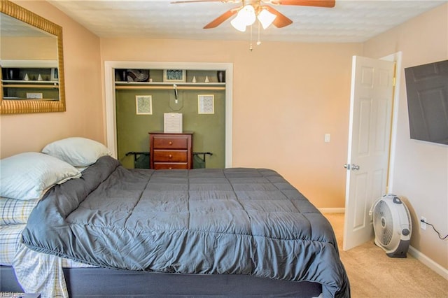 bedroom featuring a ceiling fan, carpet, a closet, and baseboards