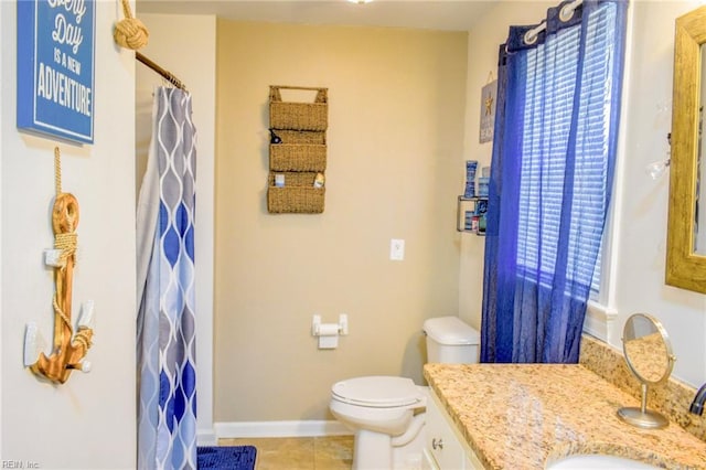 bathroom featuring tile patterned flooring, toilet, a shower with shower curtain, vanity, and baseboards