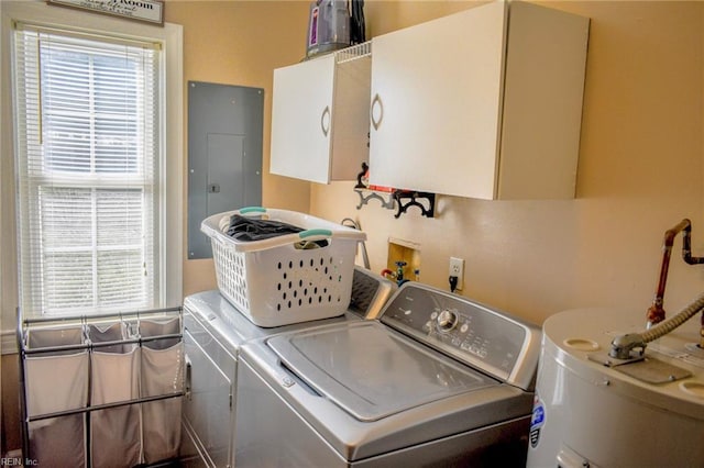 laundry area with cabinet space, washing machine and dryer, electric panel, and plenty of natural light