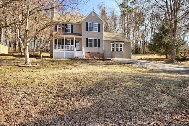 traditional-style home with crawl space, a porch, and a front yard