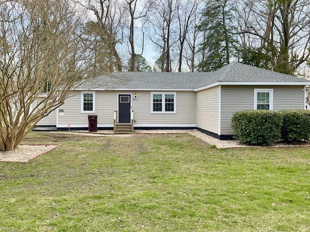 ranch-style house with entry steps, a shingled roof, and a front lawn