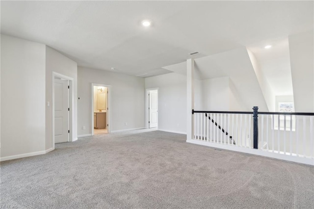 spare room with recessed lighting, carpet, visible vents, and baseboards