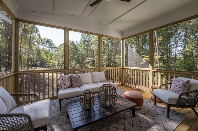 sunroom featuring a ceiling fan, an outdoor hangout area, and a healthy amount of sunlight