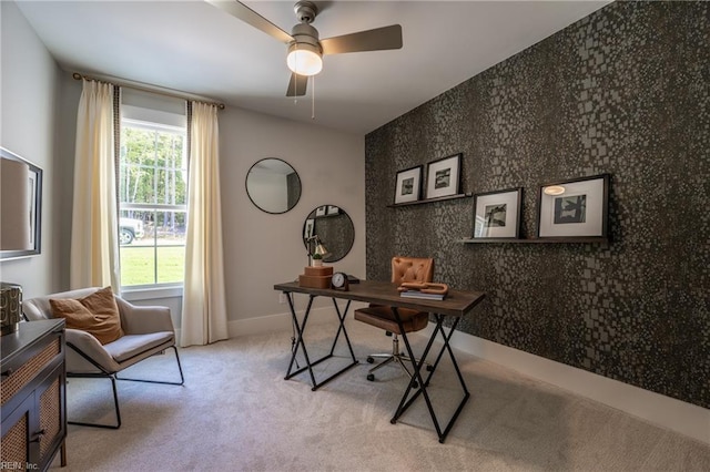 office space featuring a ceiling fan, light carpet, baseboards, and wallpapered walls