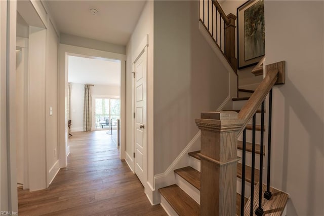 interior space featuring baseboards and wood finished floors