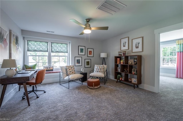 office area featuring carpet floors, baseboards, ceiling fan, and visible vents