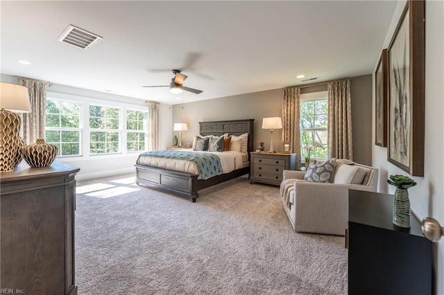 bedroom featuring a ceiling fan, visible vents, and carpet
