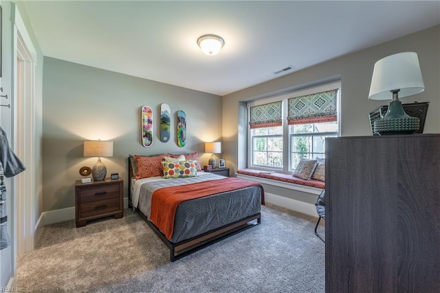 bedroom with baseboards, carpet flooring, and visible vents