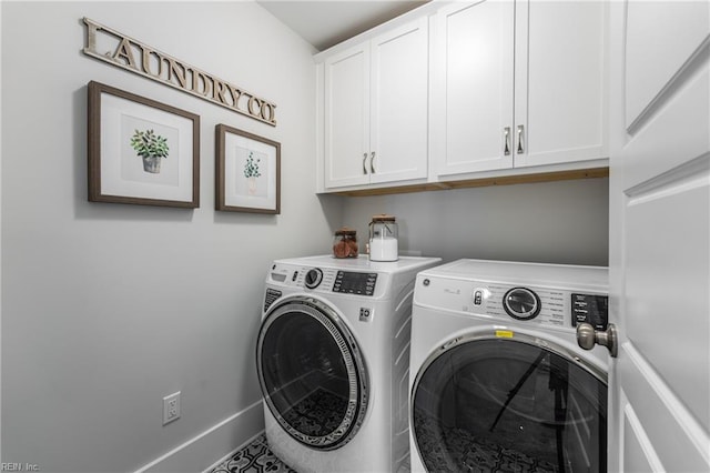 laundry room featuring baseboards, washing machine and clothes dryer, and cabinet space