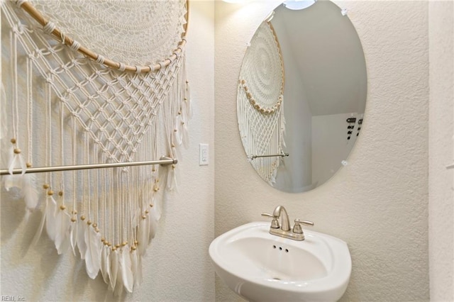 bathroom with a sink and a textured wall