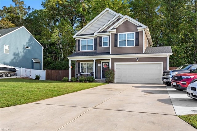 view of front of house with covered porch, concrete driveway, a front yard, and fence