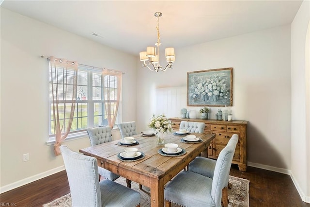 dining area featuring an inviting chandelier, visible vents, baseboards, and dark wood-type flooring