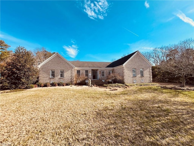 ranch-style home featuring brick siding, crawl space, and a front yard