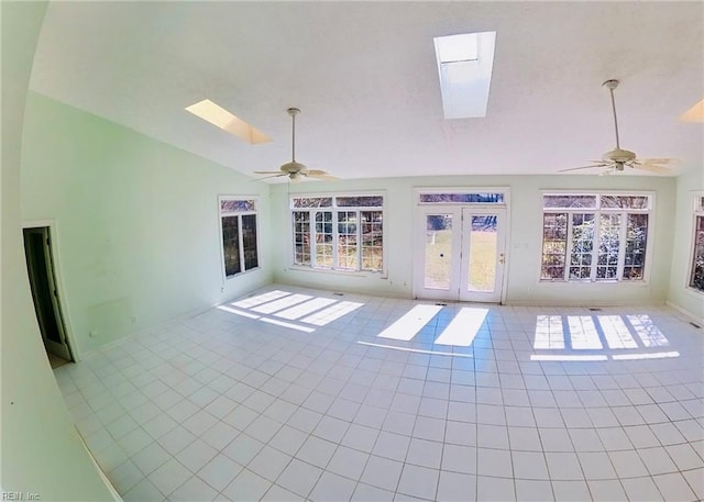 interior space with high vaulted ceiling, a skylight, ceiling fan, and tile patterned floors