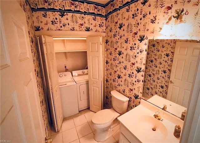 bathroom with washer and clothes dryer, tile patterned flooring, toilet, and wallpapered walls